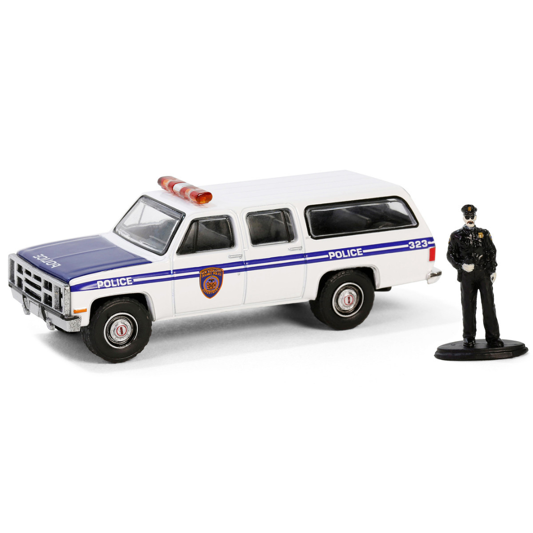 1985 GMC Suburban 2500 "New York City Transit Police Department" White with Blue Stripes and Police Officer Figure "The Hobby Shop" Series 16 1/64 Diecast Model Car