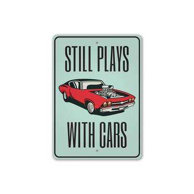 still-plays-with-cars-aluminum-sign