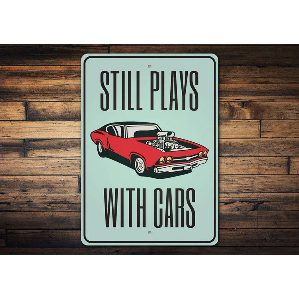 still-plays-with-cars-aluminum-sign