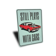 still-plays-with-cars-aluminum-sign